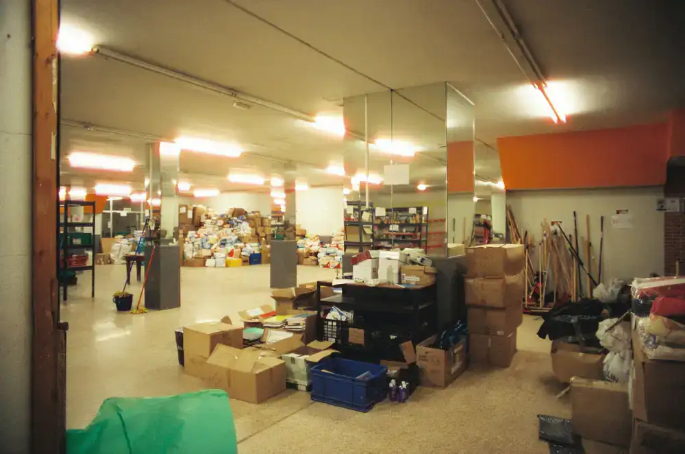 Large wooden shelves packed with hundreds of colorful board game boxes