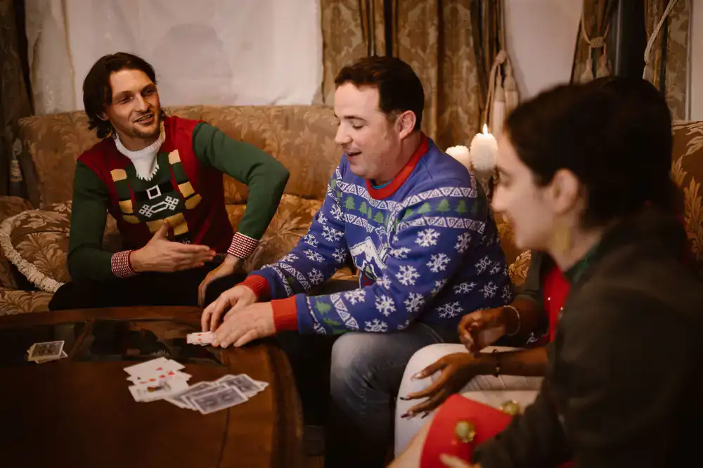 A group of friends laughing while playing a fast-paced card game
