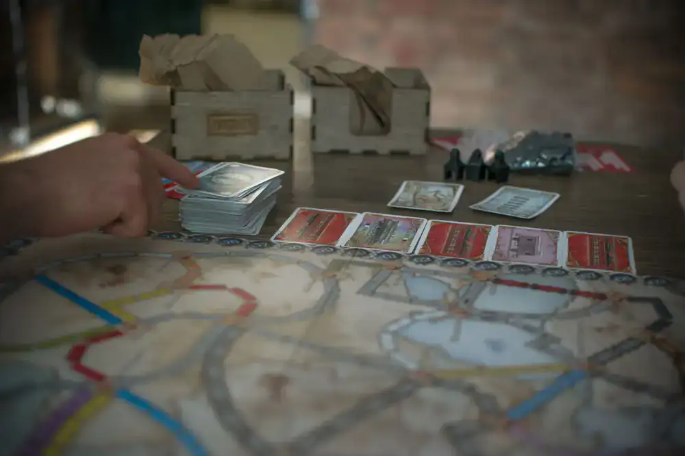Close up of a complex strategy board game with wooden pieces and cards