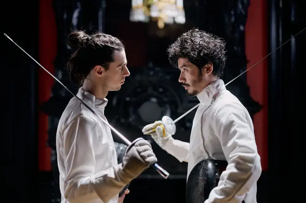Two people deeply focused on a head-to-head card duel