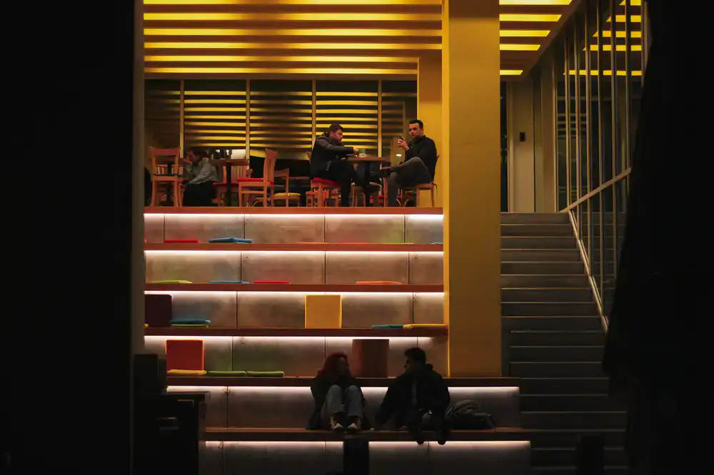 Cosy café interior with warm lighting and people playing games